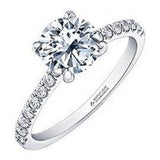 Brilliant cut solitaire engagement ring with diamond shoulders