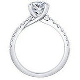 Brilliant cut solitaire engagement ring with diamond shoulders